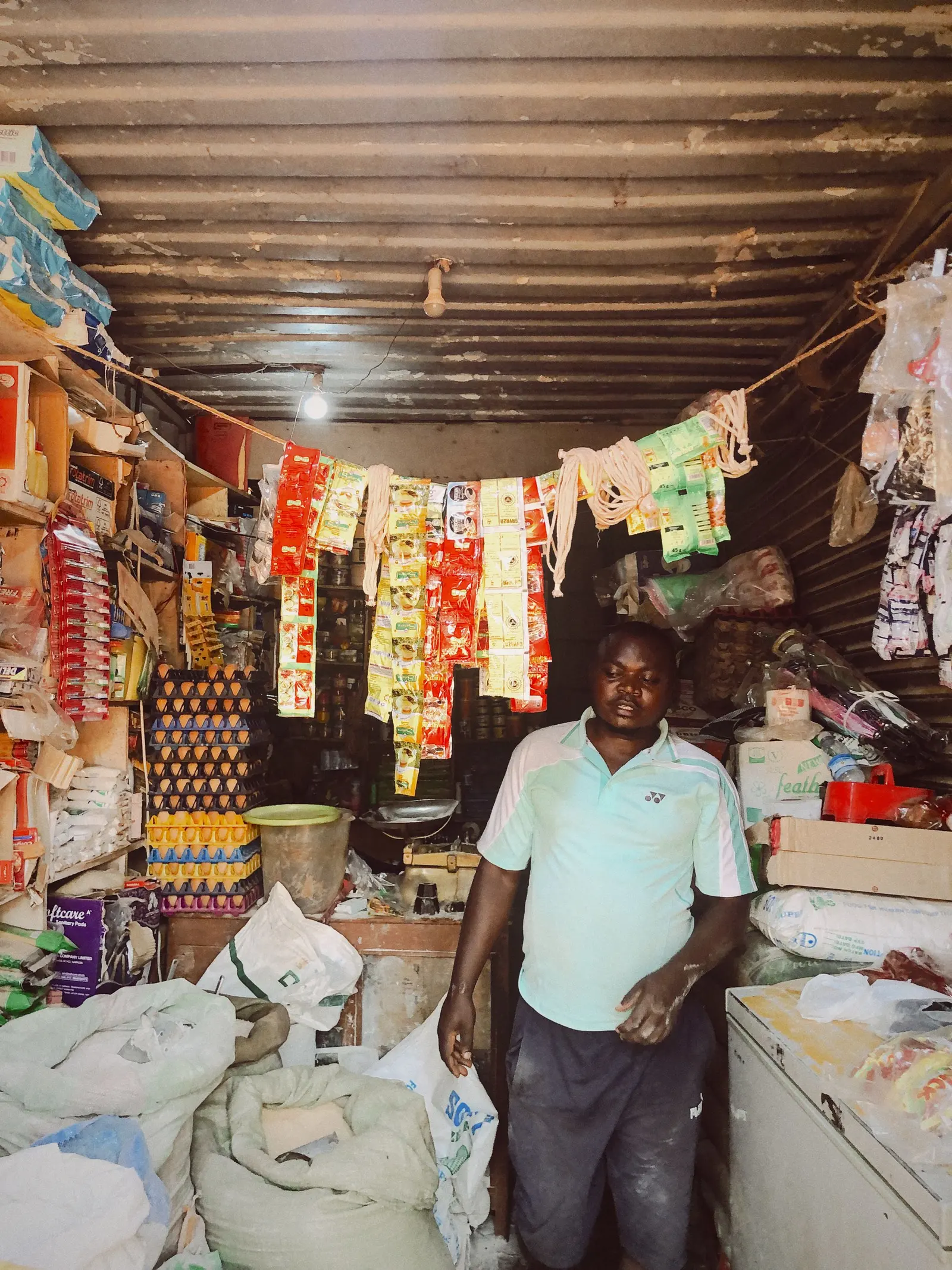 Shopkeeper in Kenya at the counter of his shop