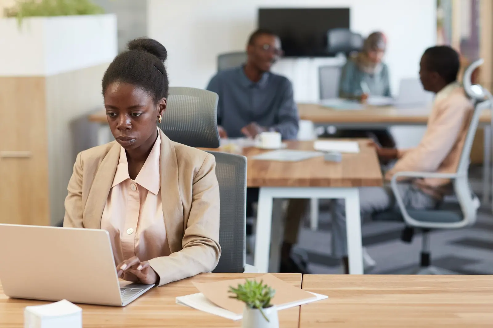 Business owner in Nairobi reviewing her new website on a laptop