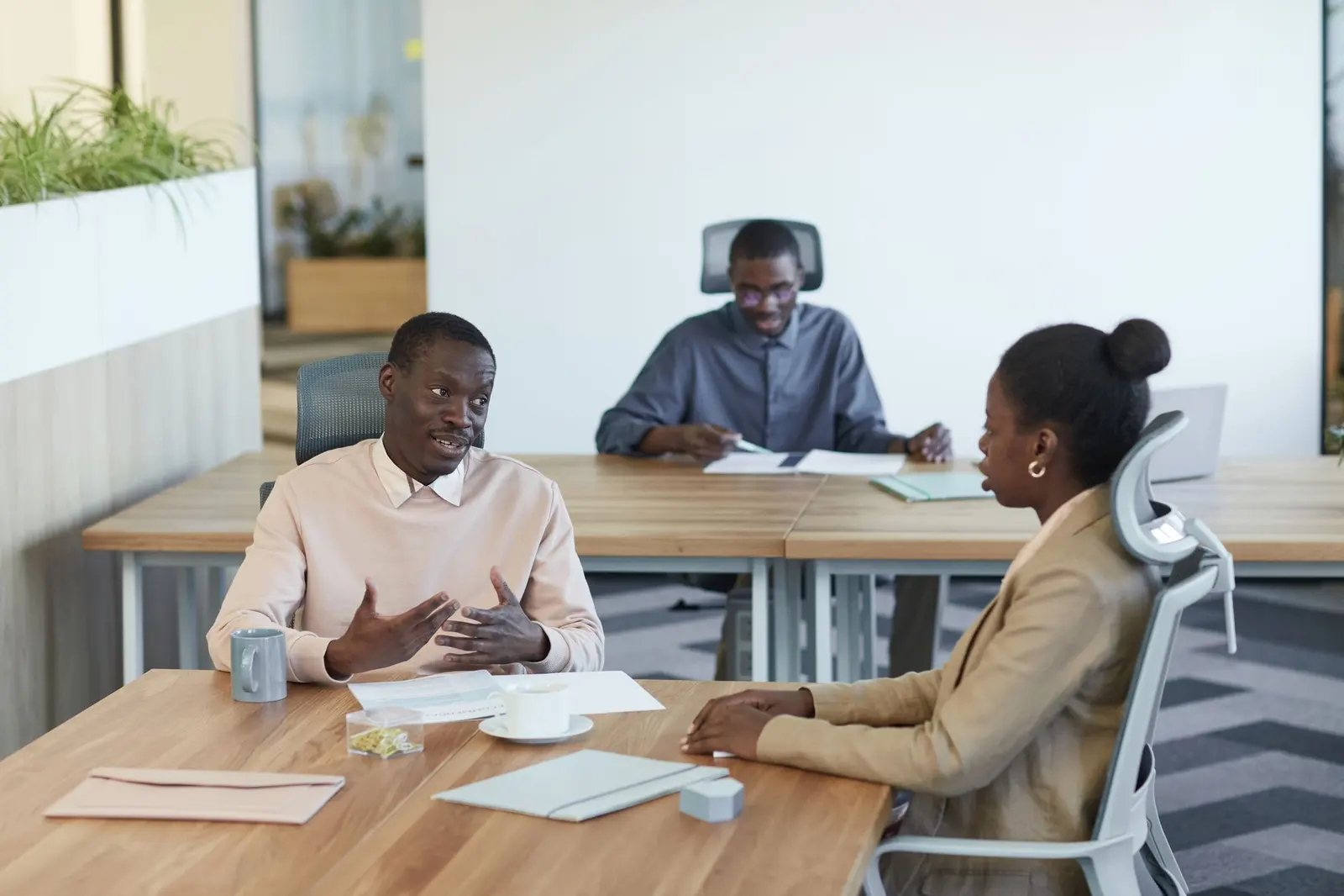 Marketing team planning an ad campaign around a laptop