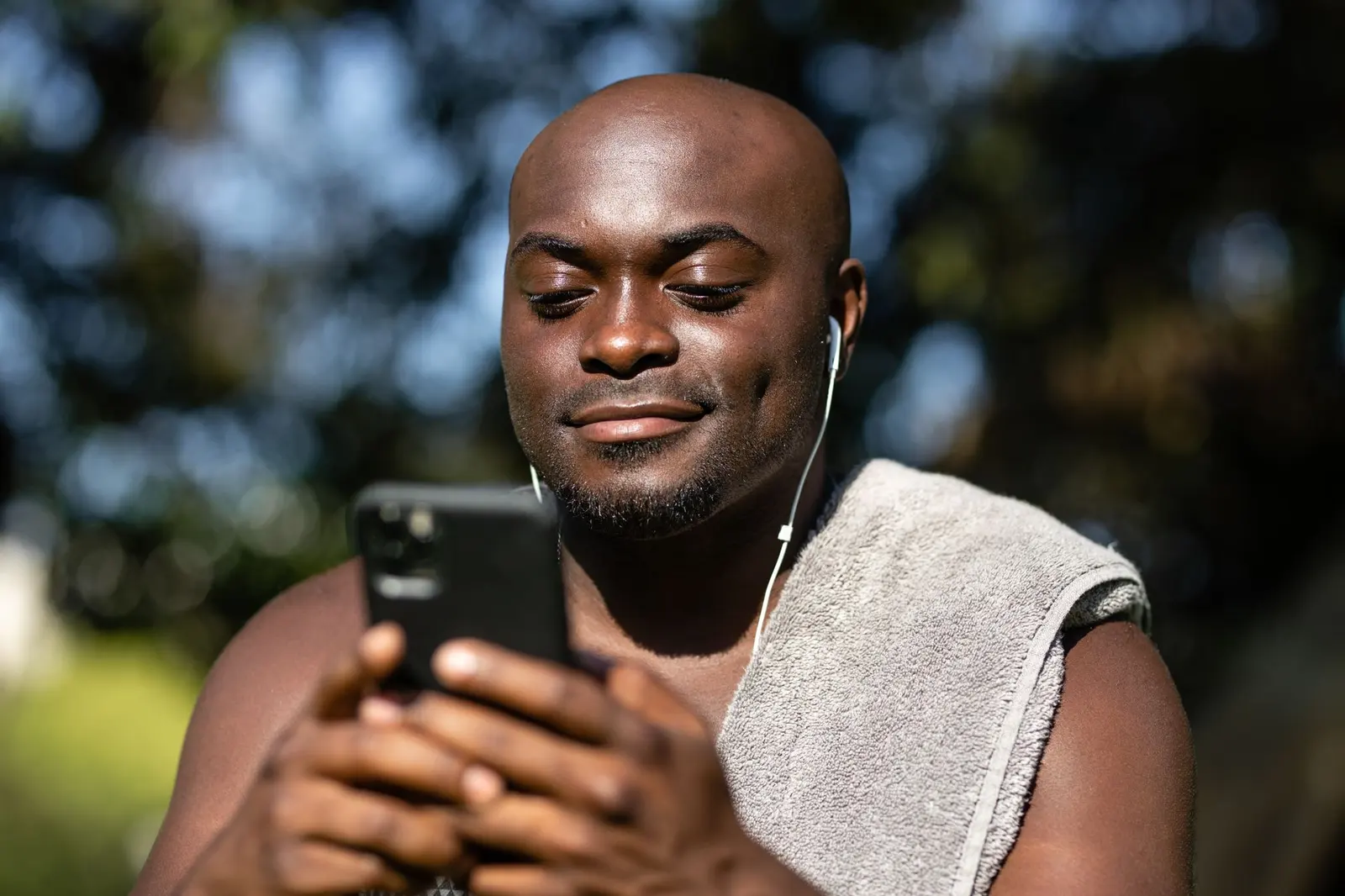Business owner smiling as enquiries arrive on his phone