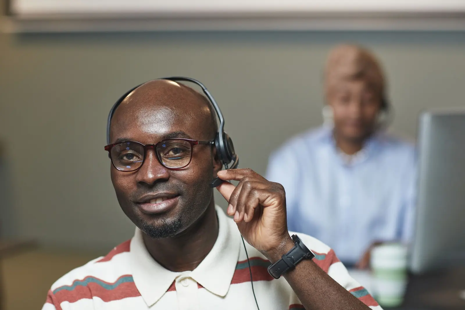 Customer care agent smiling on a call